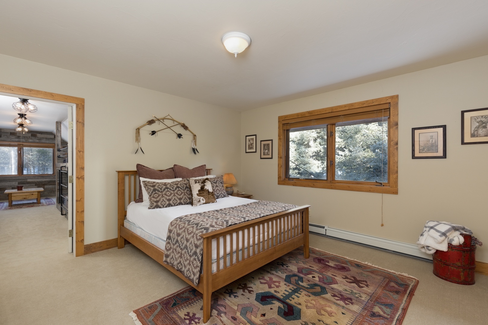 Rest peacefully in your cozy bedroom with rustic charm, soft linens, and mountain views through large windows.