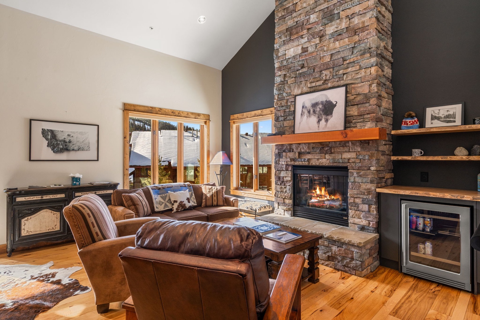 Sink into plush leather seating by the crackling stone fireplace, where warm flames create the perfect ambiance for your mountain getaway.