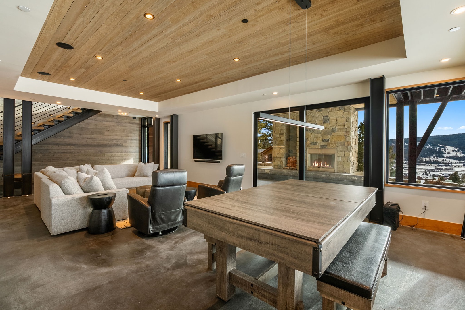 Relax in your spacious living area with stunning mountain views, warm wood accents, and cozy fireplace.