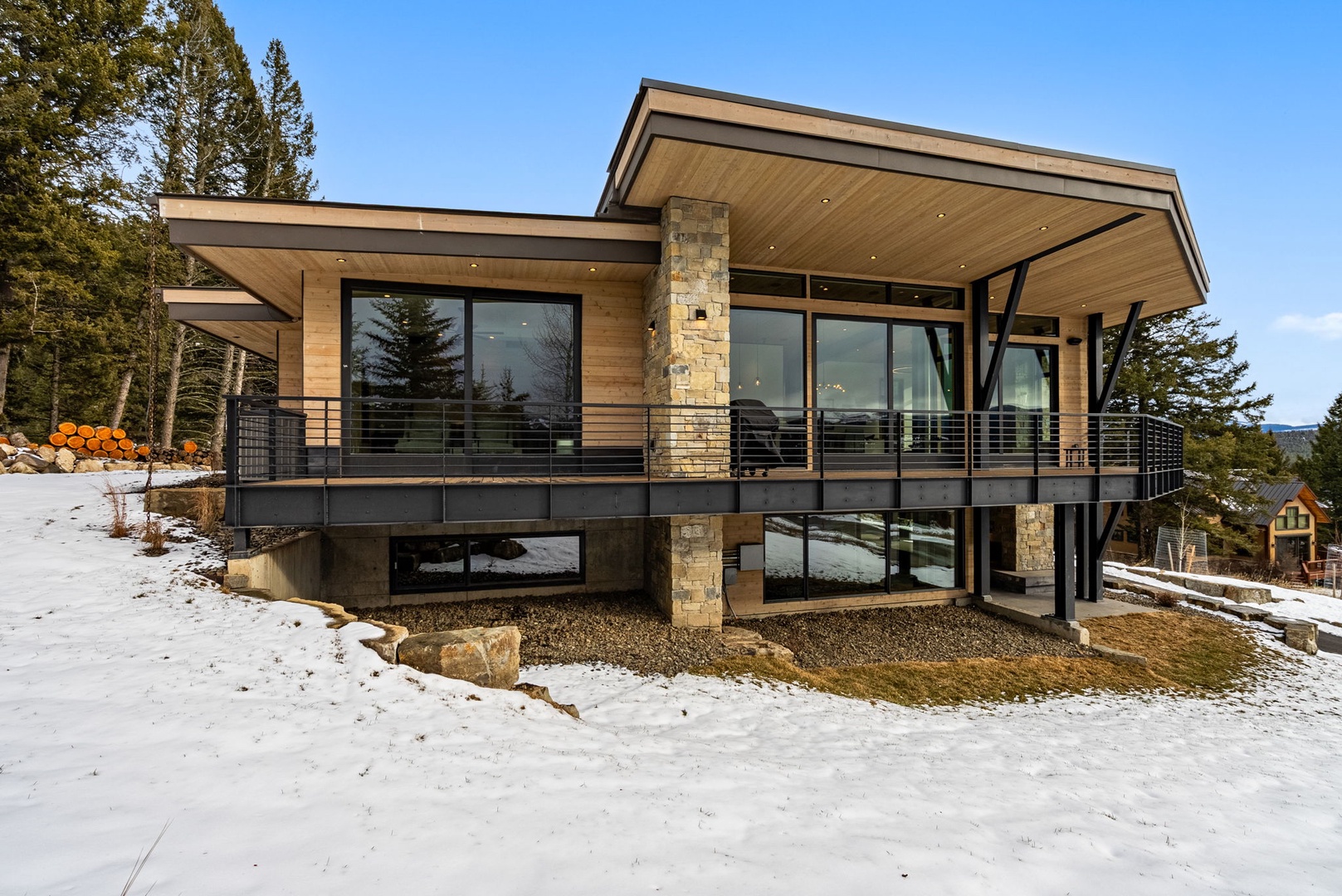 Modern architectural design meets mountain serenity in this stunning contemporary property nestled among evergreen trees.