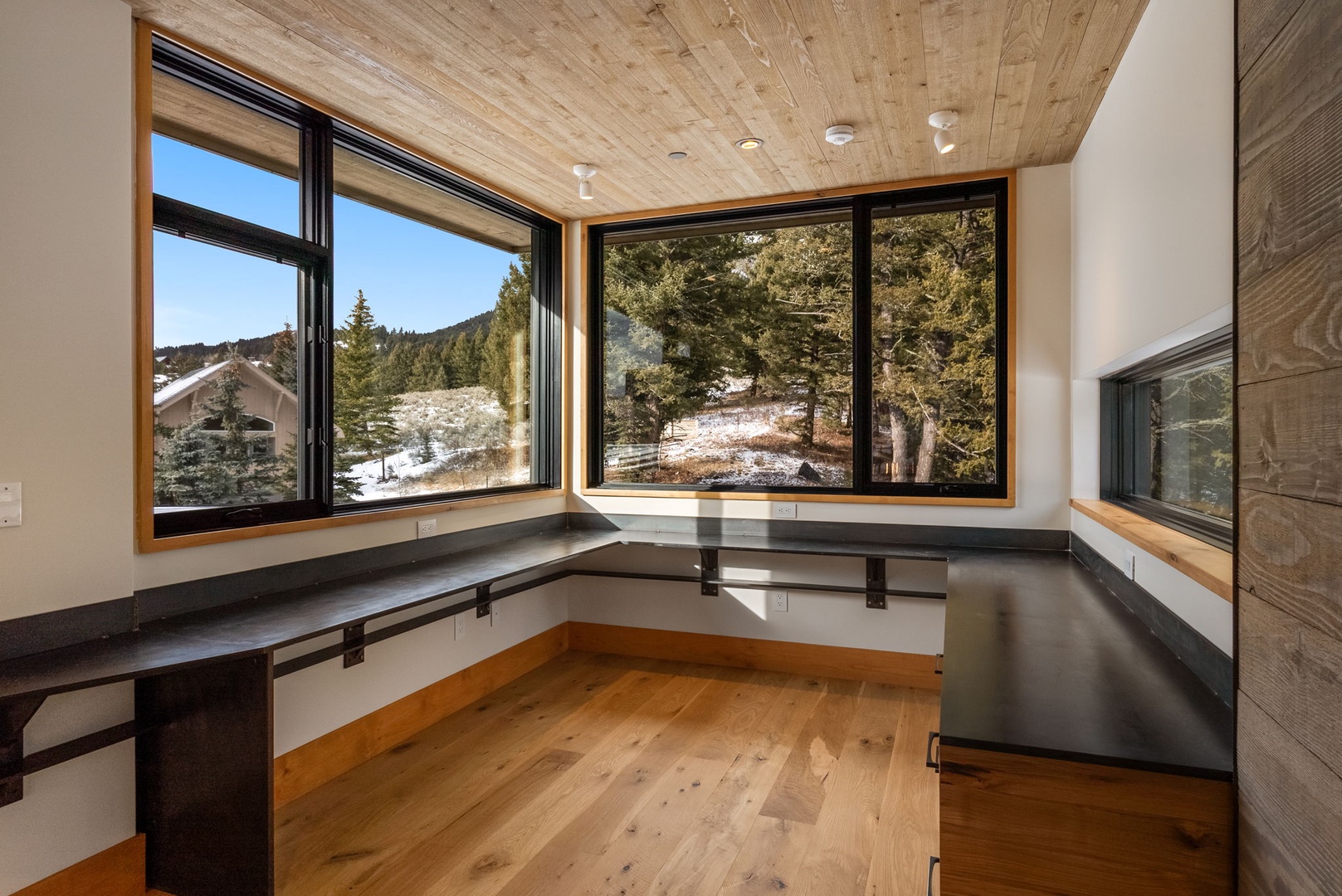 Your breakfast nook frames stunning mountain and forest views through floor-to-ceiling windows, creating the perfect morning retreat.