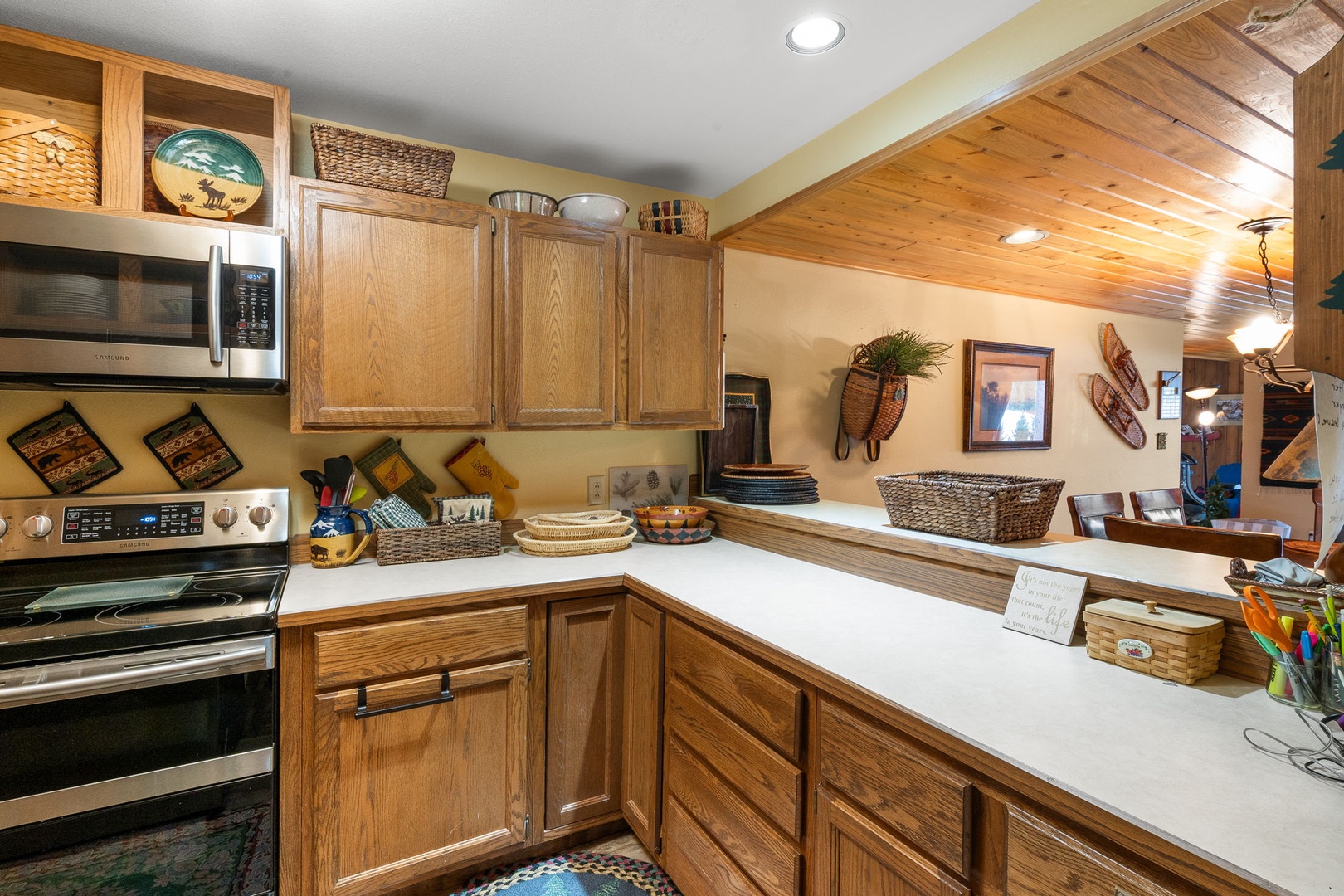 Cook your favorite meals in this charming kitchen featuring warm wood cabinets, modern appliances, and plenty of counter space for culinary adventures.