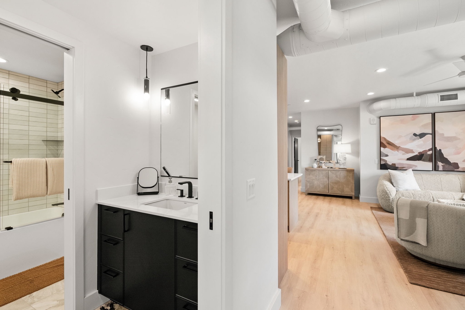 Step into a thoughtfully designed space where modern elegance meets comfort. Warm wood floors guide you through an open layout featuring contemporary finishes, high ceilings, and a soothing neutral palette that invites you to unwind.