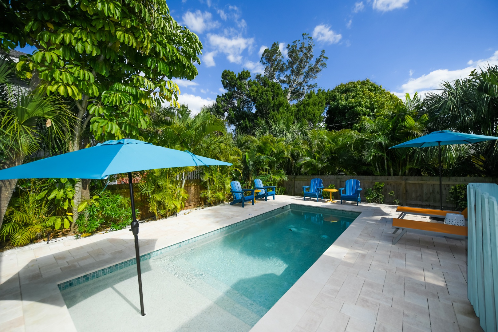 Pool with Umbrella and Lounge Chairs