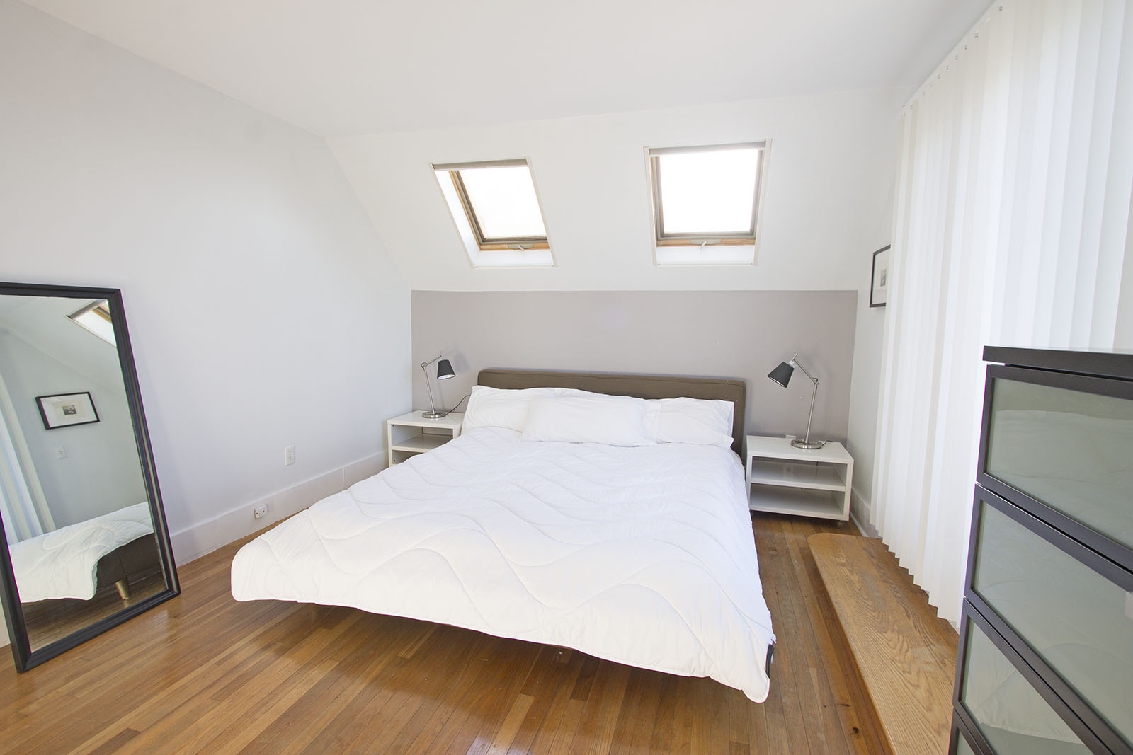 BR 1: Master bedroom with skylights and sliders to a balcony.