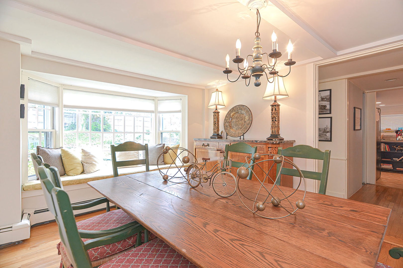 The dining room seats eight with bay windows looking out to the verdant courtyard.