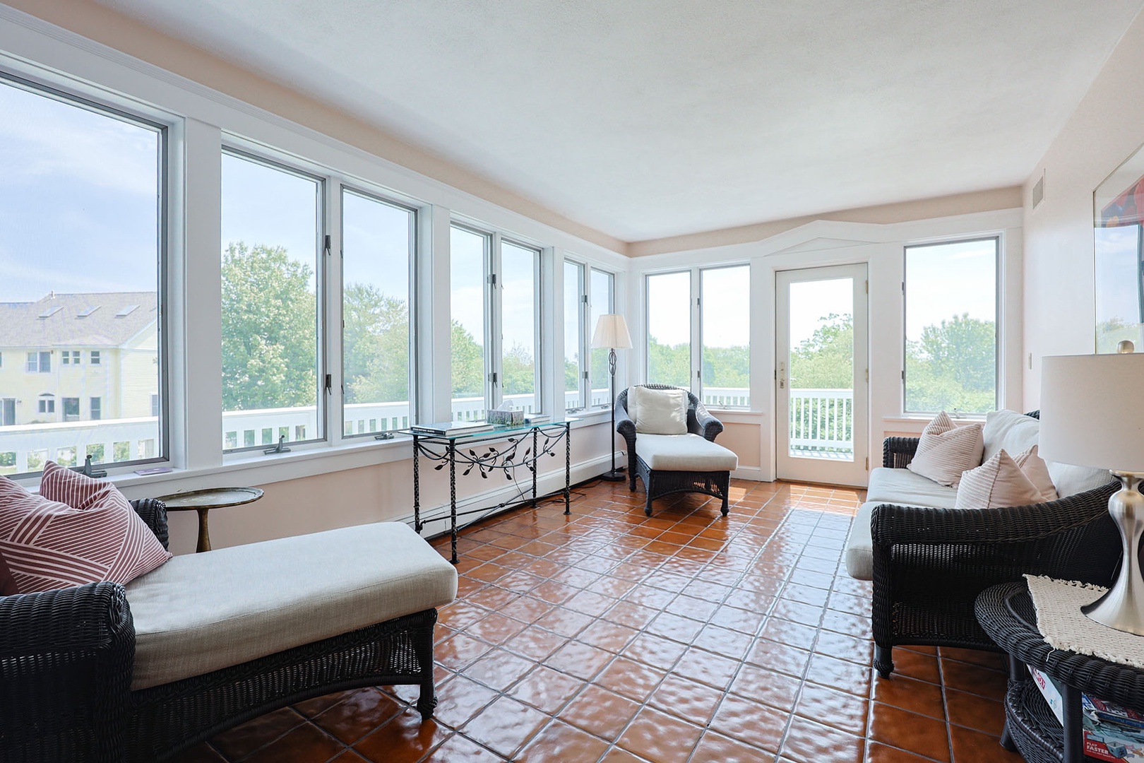 The sun porch is flanked by a wraparound deck.