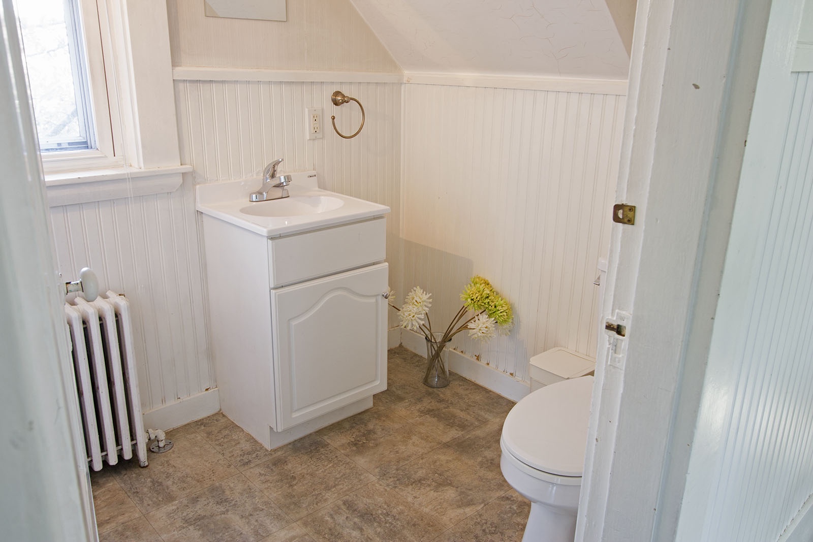 Main floor half bath off of the kitchen.