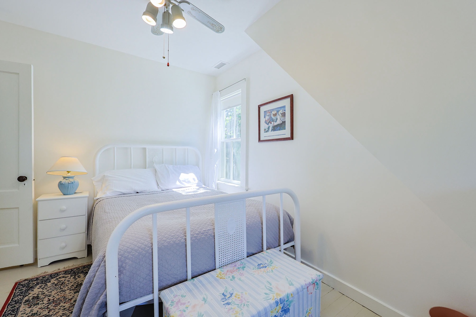 Bedroom 2 with a double bed & a ceiling fan.