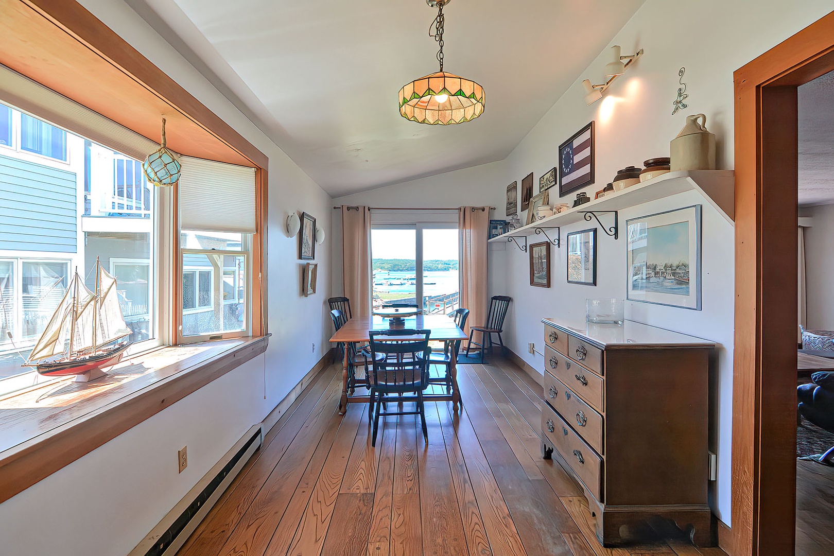 The kitchen opens to a dining area and sliders to the back porch.