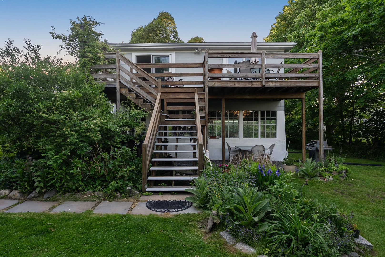 The guest apartment is on the upper level, with a grill and dining area below.