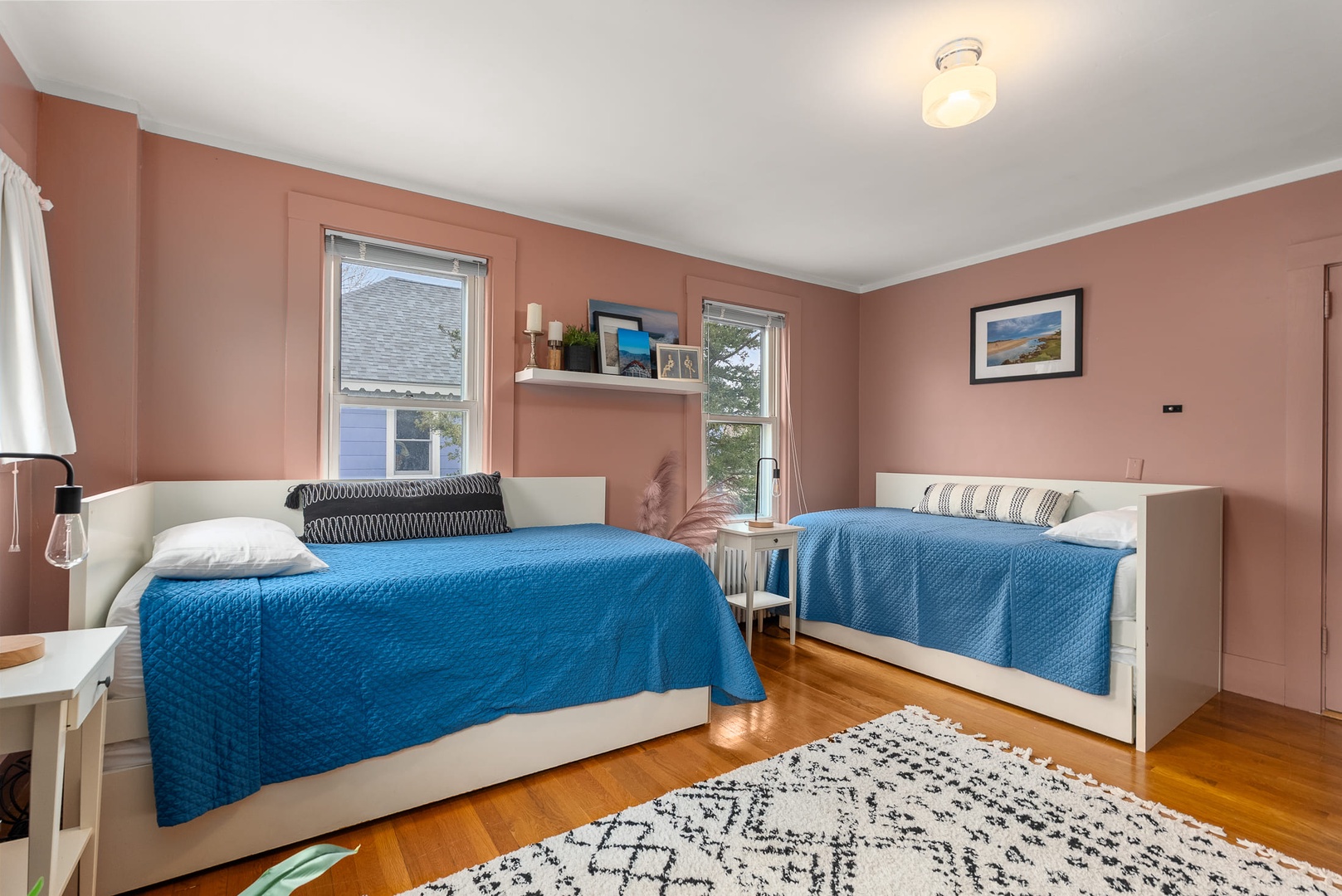 Bedroom 3: A bright corner bedroom with twin beds.