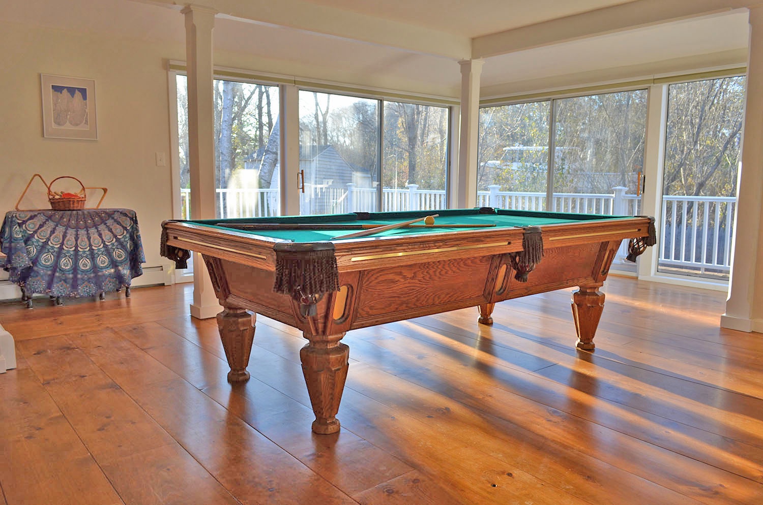 The large sliders and floor-to-ceiling windows let in the afternoon light.