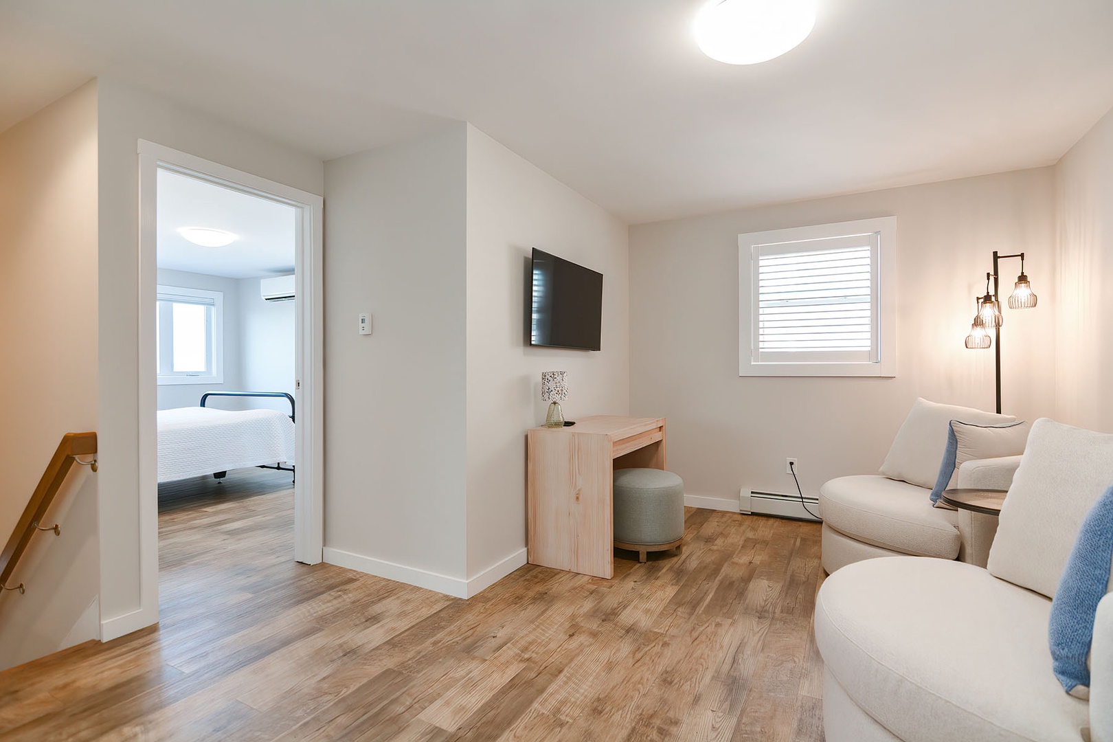 Second floor landing with a desk and tv.