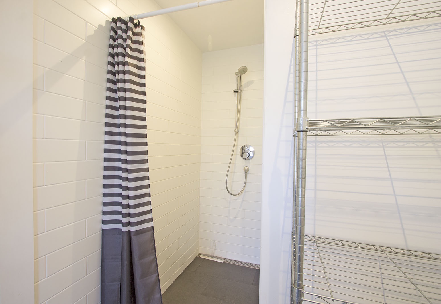 Upstairs is a European-style full bath with walk-in shower.