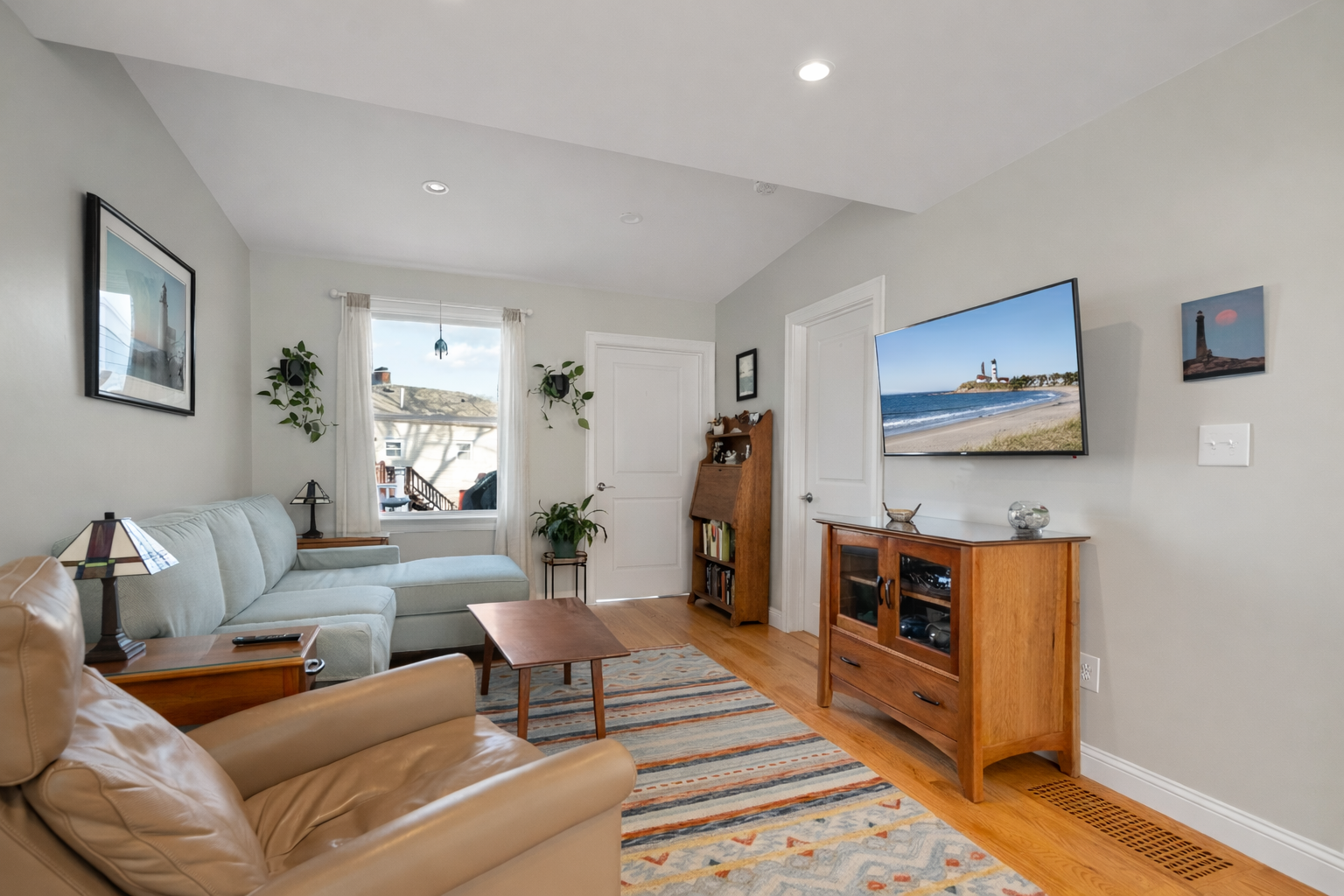 The living room is spacious and includes a flatscreen TV.