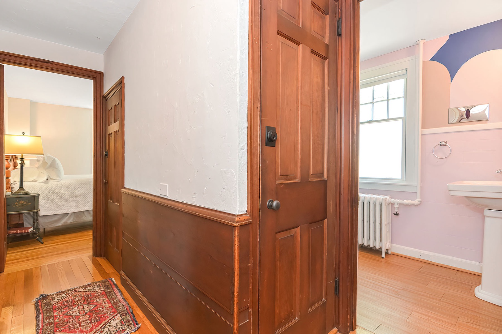 Hall view to Bedroom 1 and the second floor full bath.