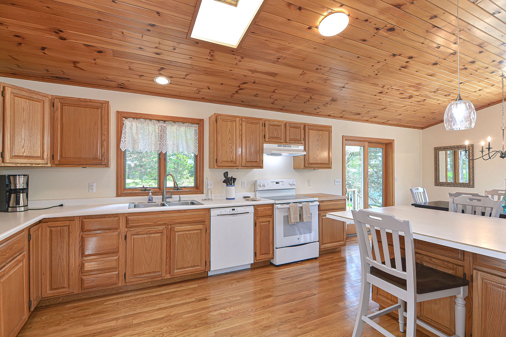 Large fully-applianced kitchen with a peninsula breakfast bar and plenty of counter space for meal prep.