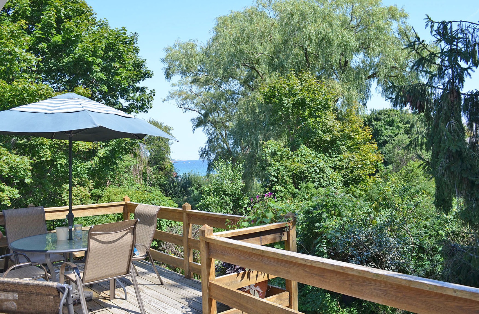 Enjoy peek-a-boo views of the sea from the deck.