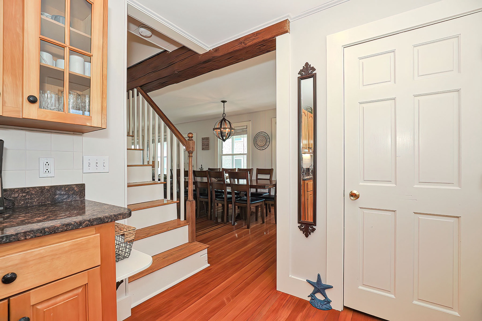 The stairs to the second level are just past the kitchen.