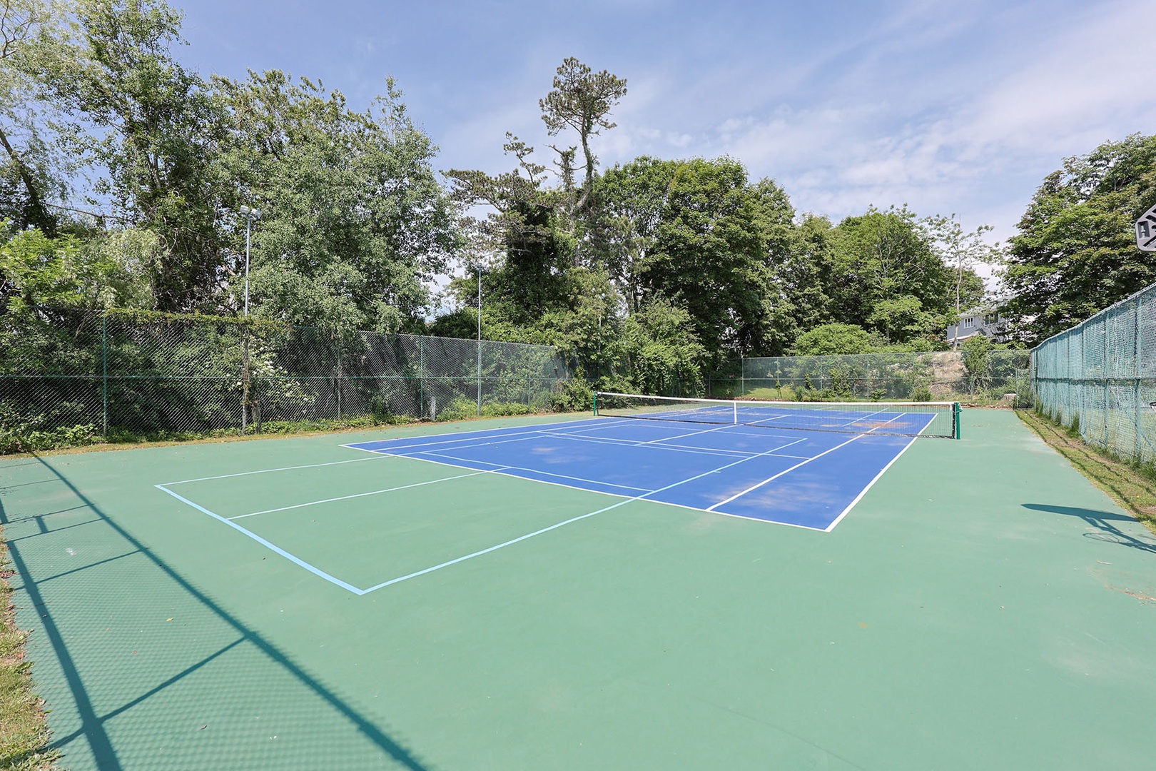The tennis court doubles as a pickleball court for added fun.