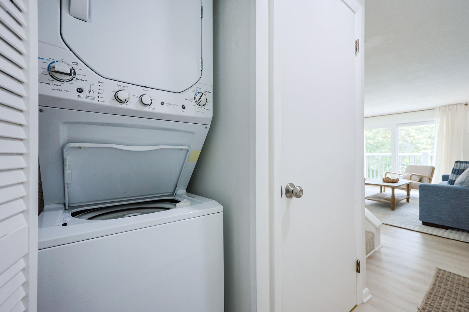 The washer and dryer are located between the living room and the kitchen.