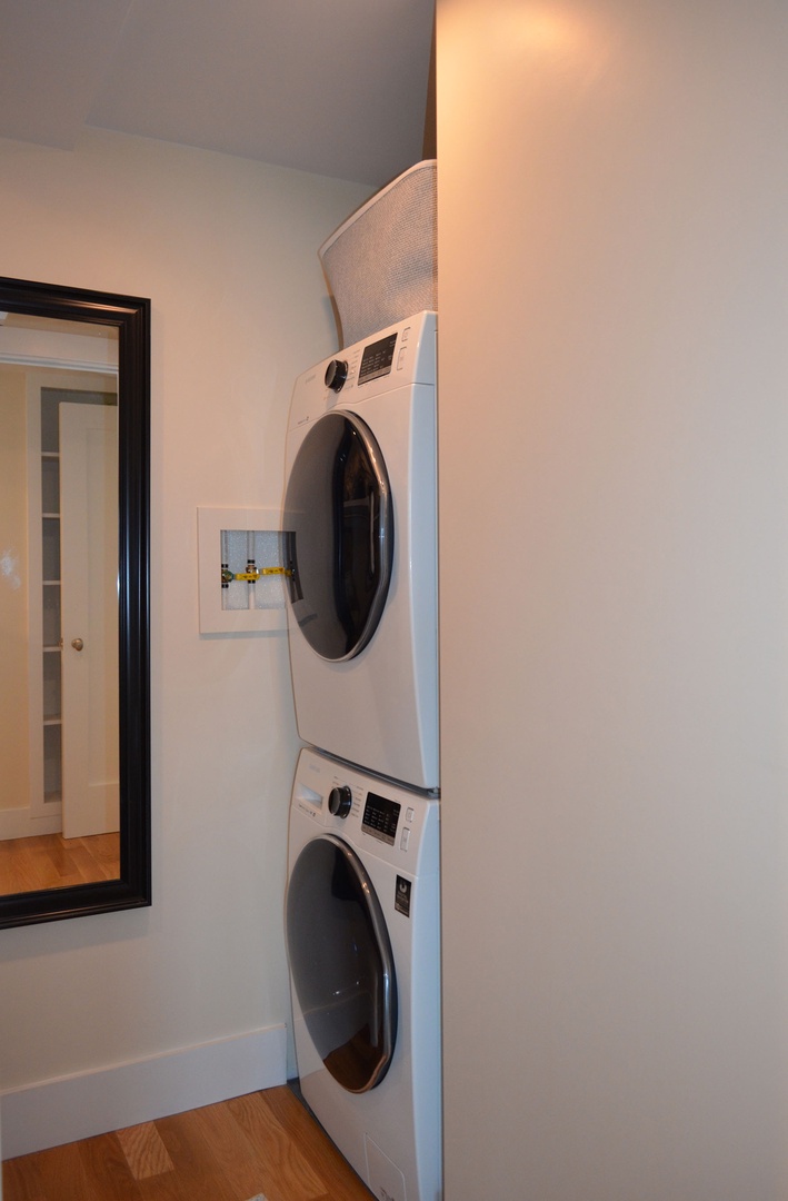 The washer and dryer are in the closet off of the hall.