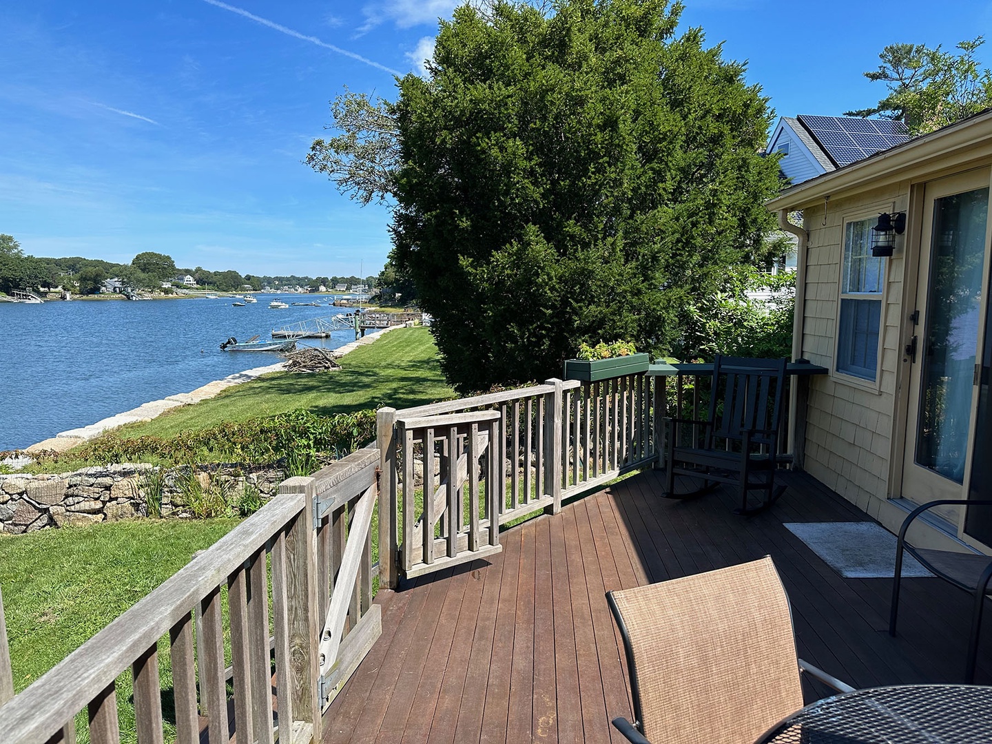 The generously sized deck overlooks the water.