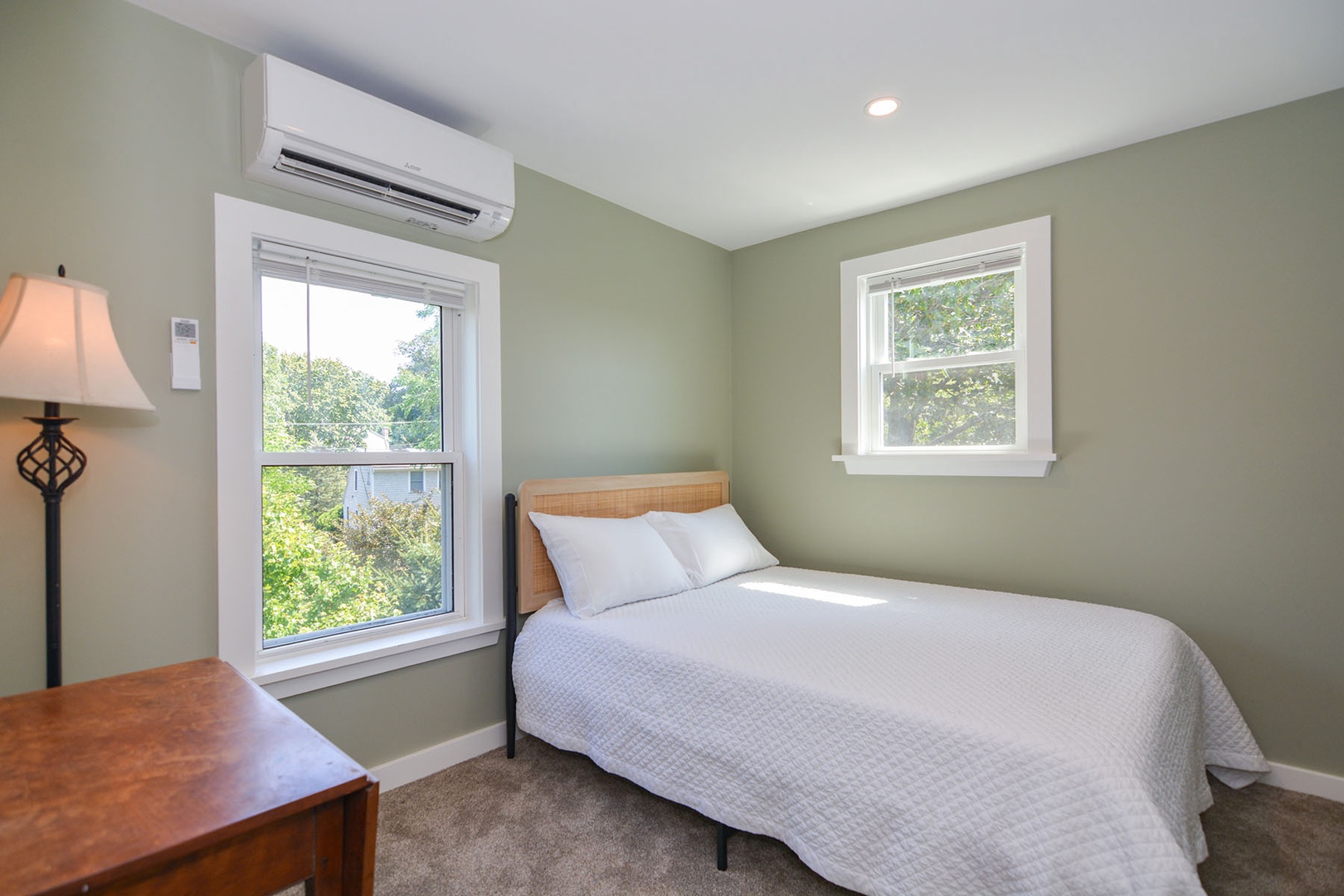 The primary bedroom includes a small desk and views outside.