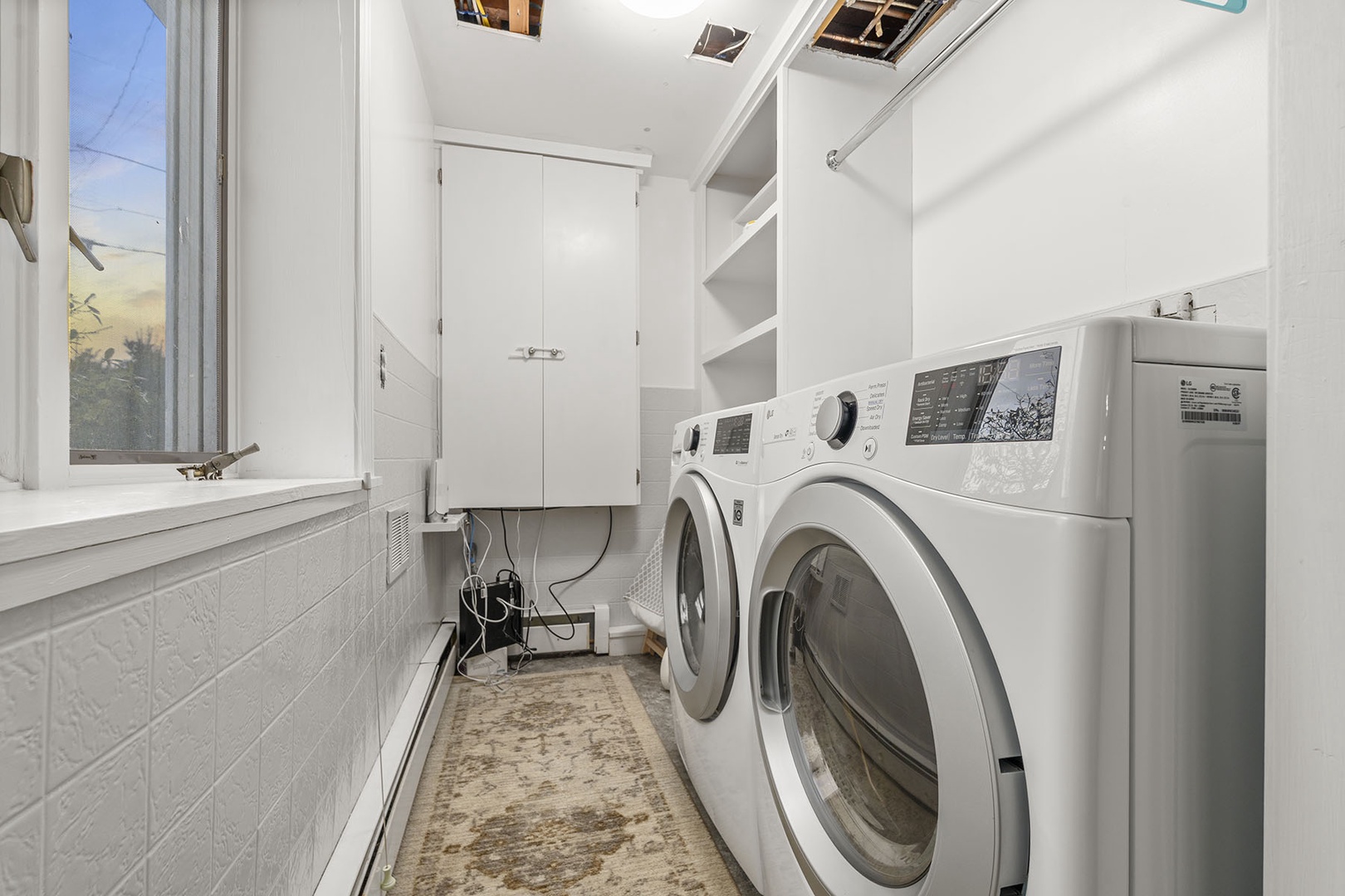 The laundry room is located off of the lower floor living room area.