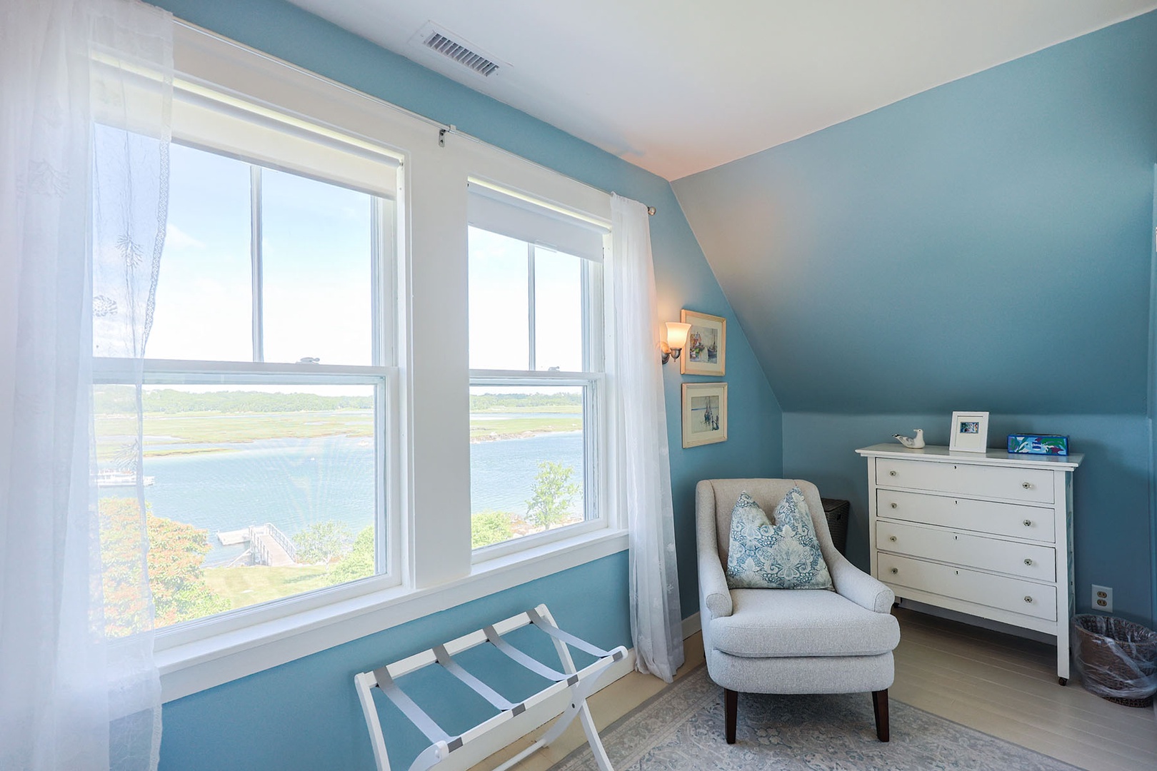 Primary bedroom with scenic river views.