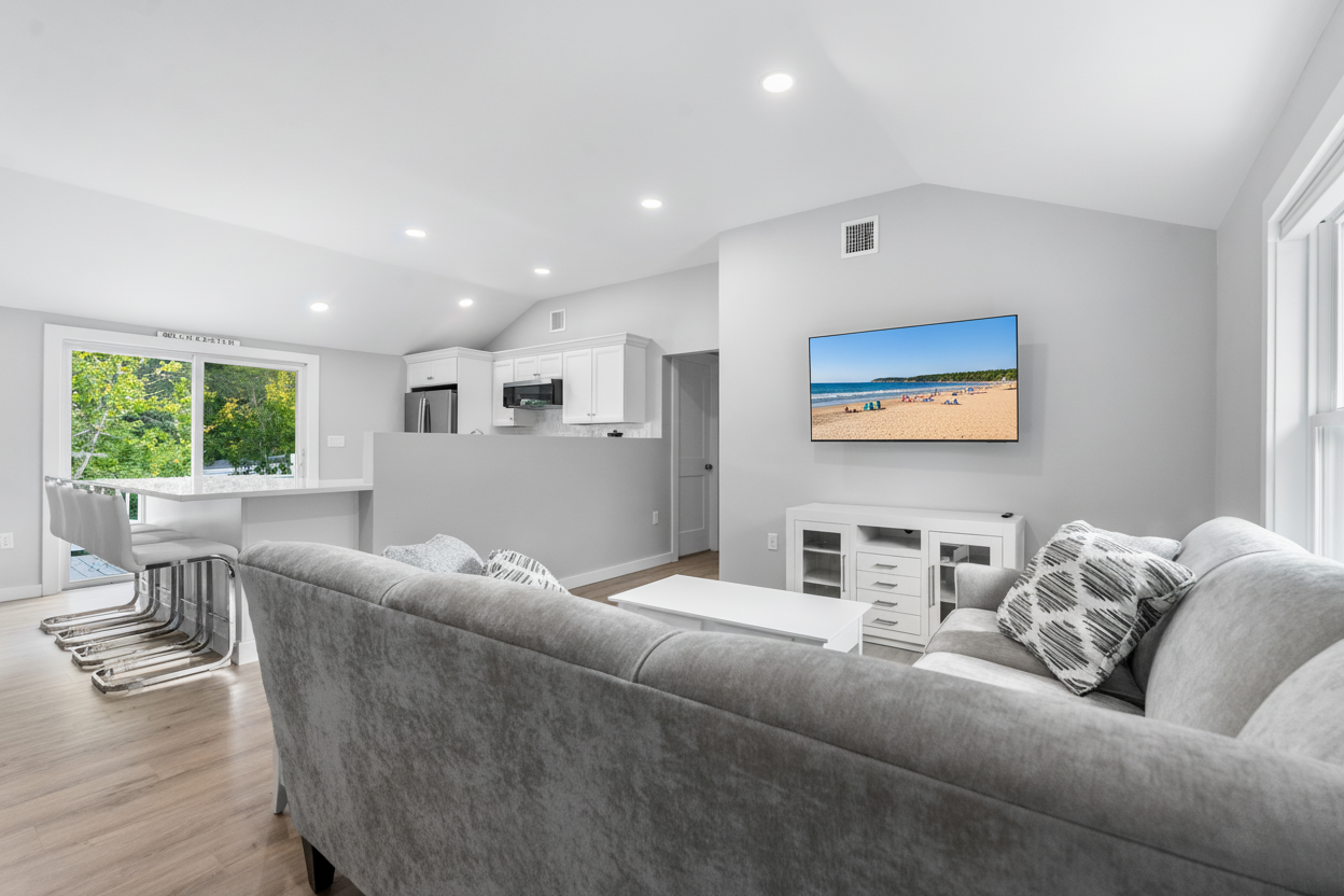 Spacious and comfortable living room with a TV.