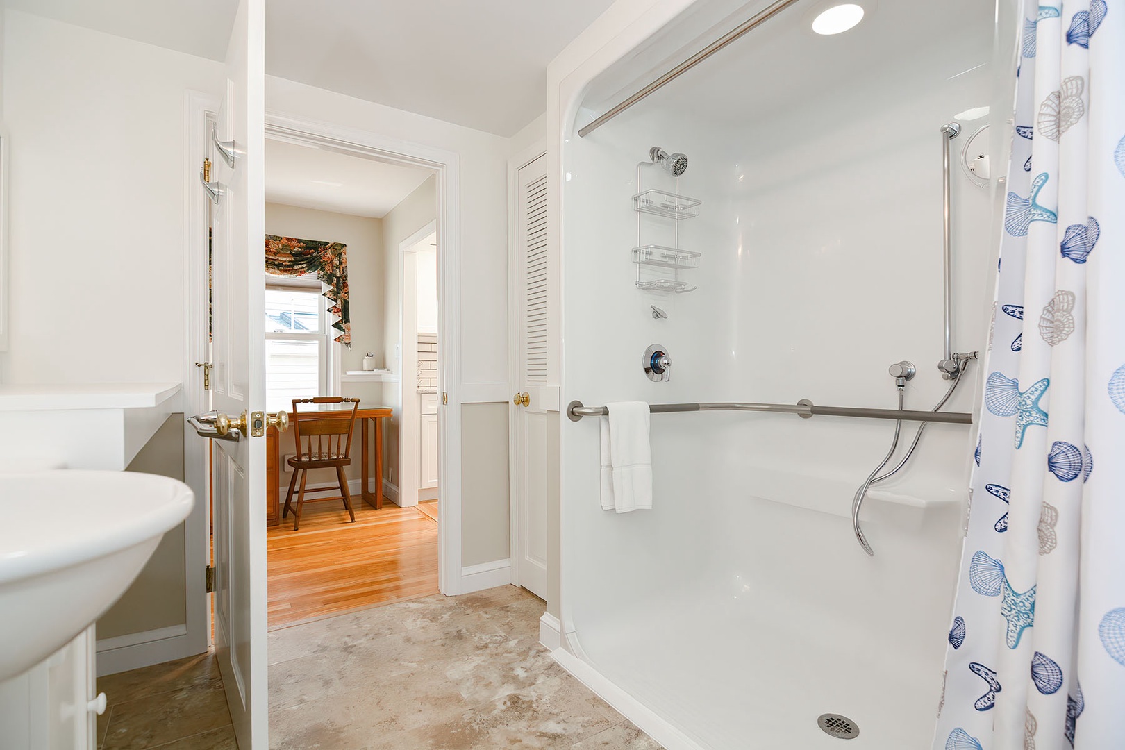 Ground floor bathroom includes a walk-in shower that has a shower seat and grab bars.