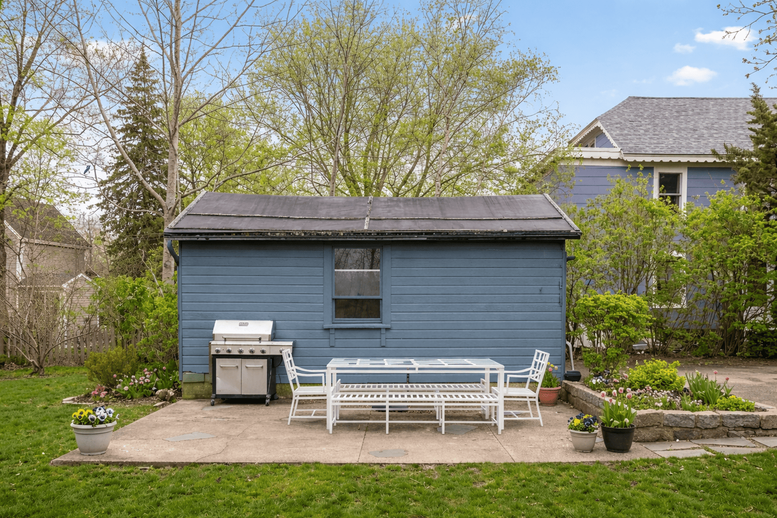 The grill and sitting area, surrounded by lush greenery.