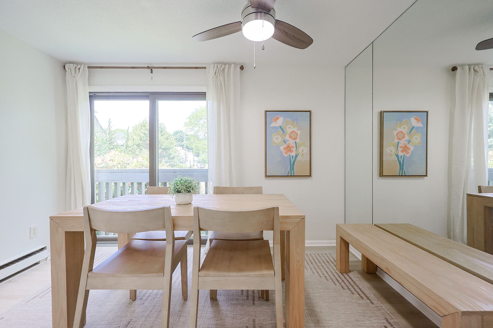 There is a large mirror to the wall near the dining area.