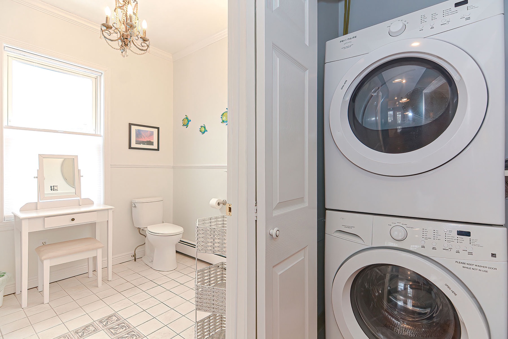 A stacked washer/dryer is just outside Bathroom 1.