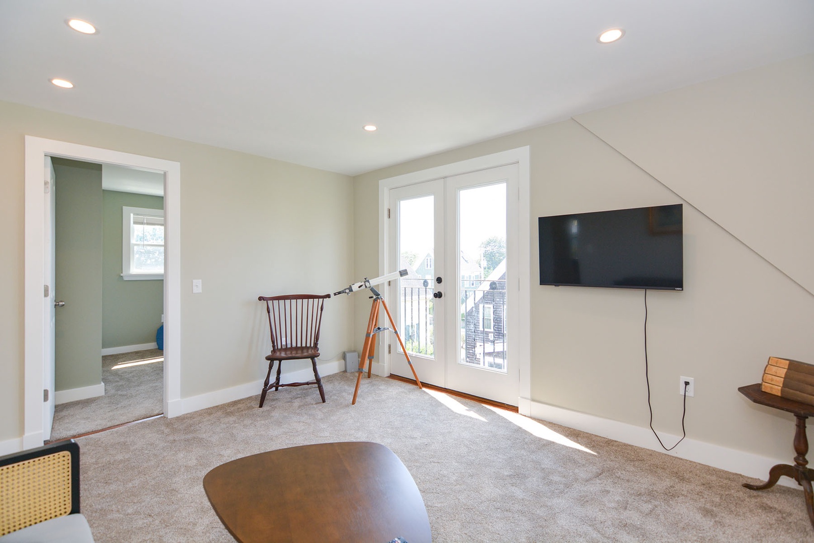 Living room includes a TV and a telescope.
