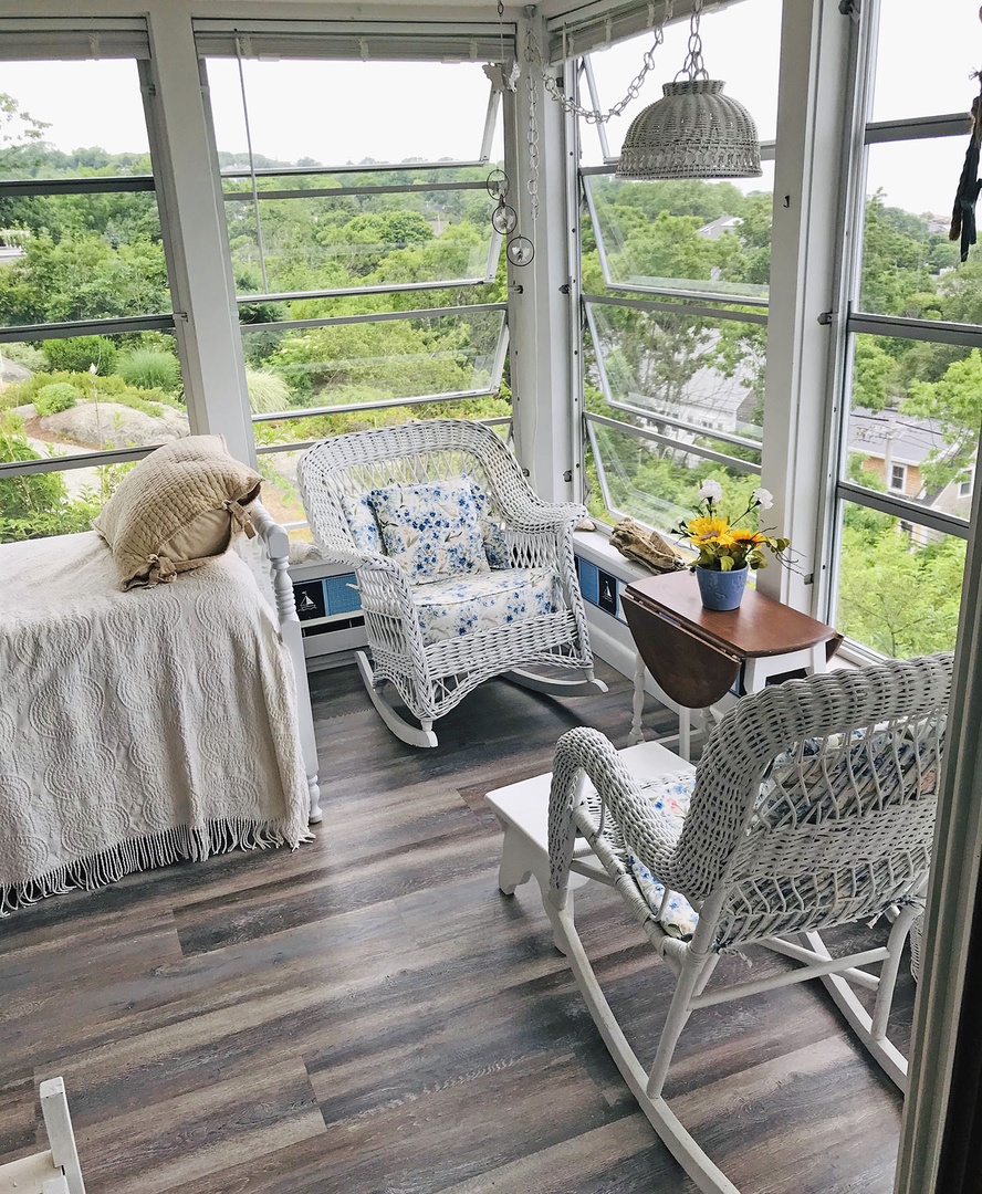 Relax on the seasonal glassed-in porch on the daybed or rockers.