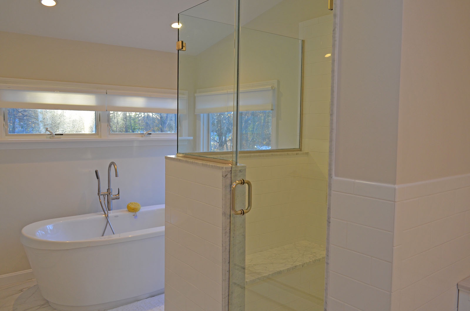 BR 1: Views of the walk-in shower and soaking tub in the Primary Bedroom ensuite bath