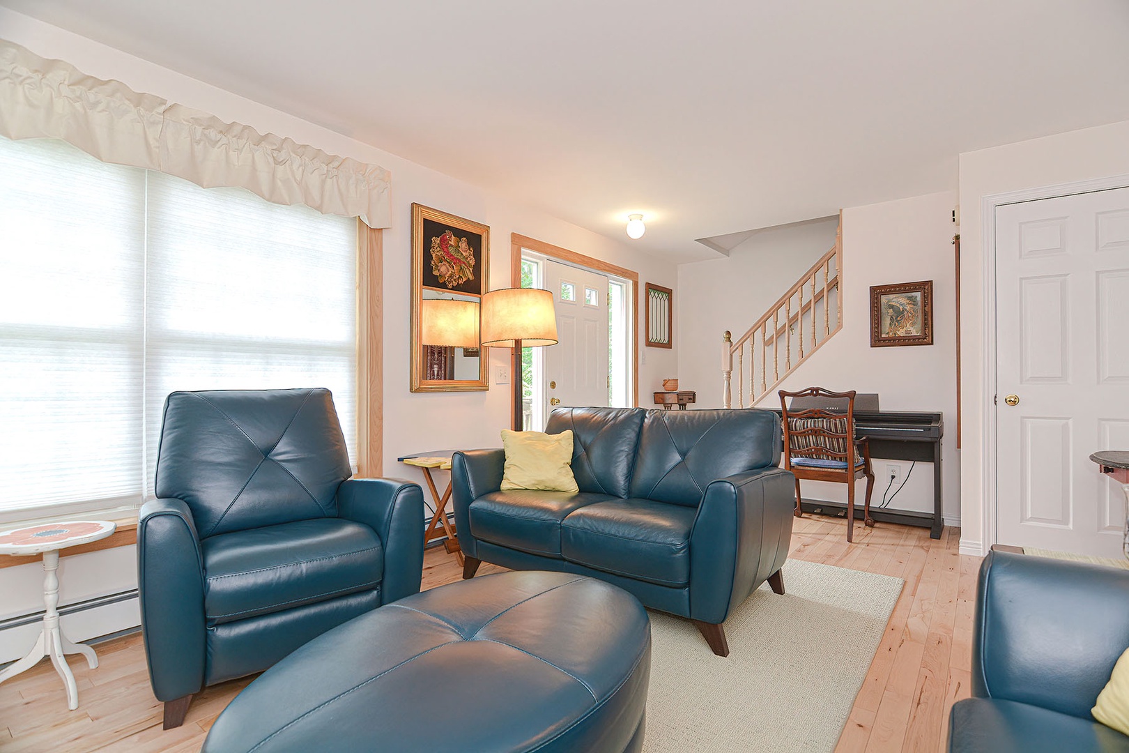 Living room with leather sofas and fireplace.