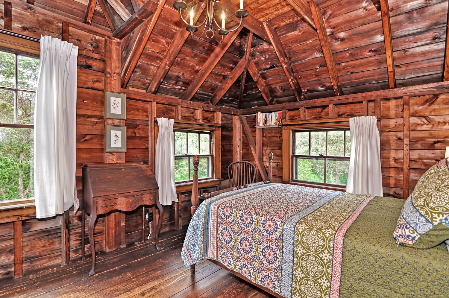 The cozy Treehouse room has lovely views of the woods.