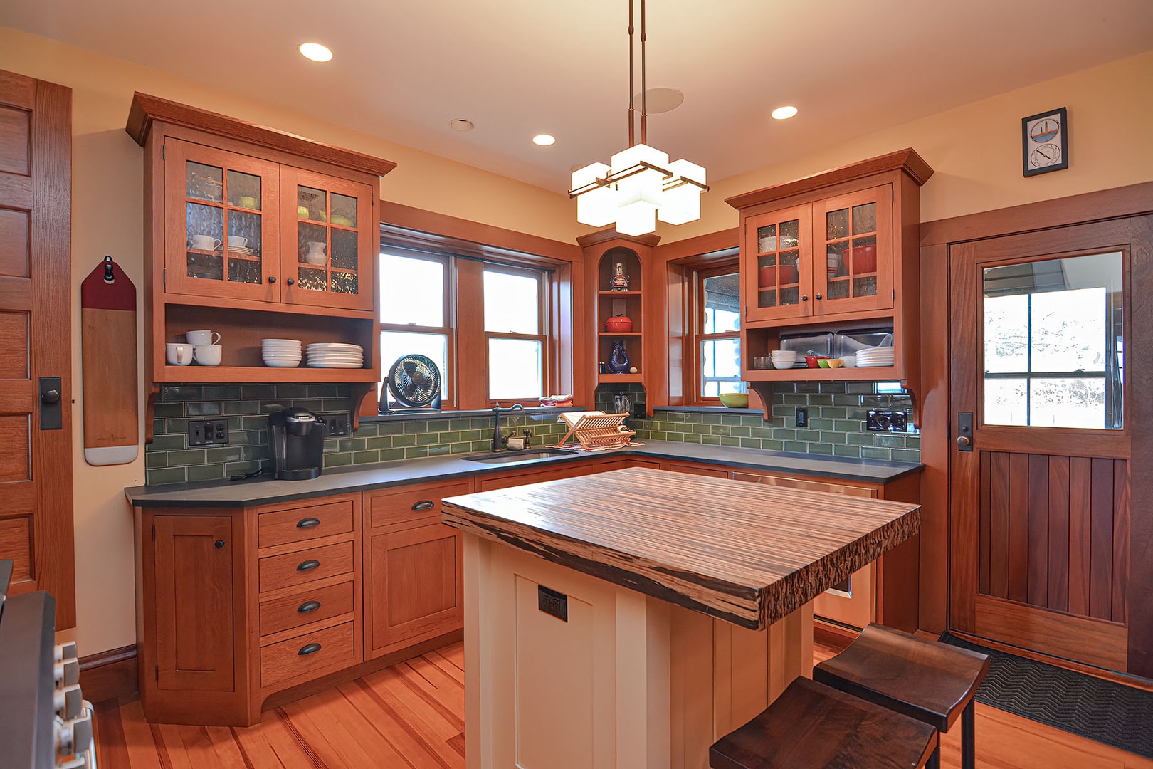 The kitchen has beautiful wood cabinetry and slate countertops.