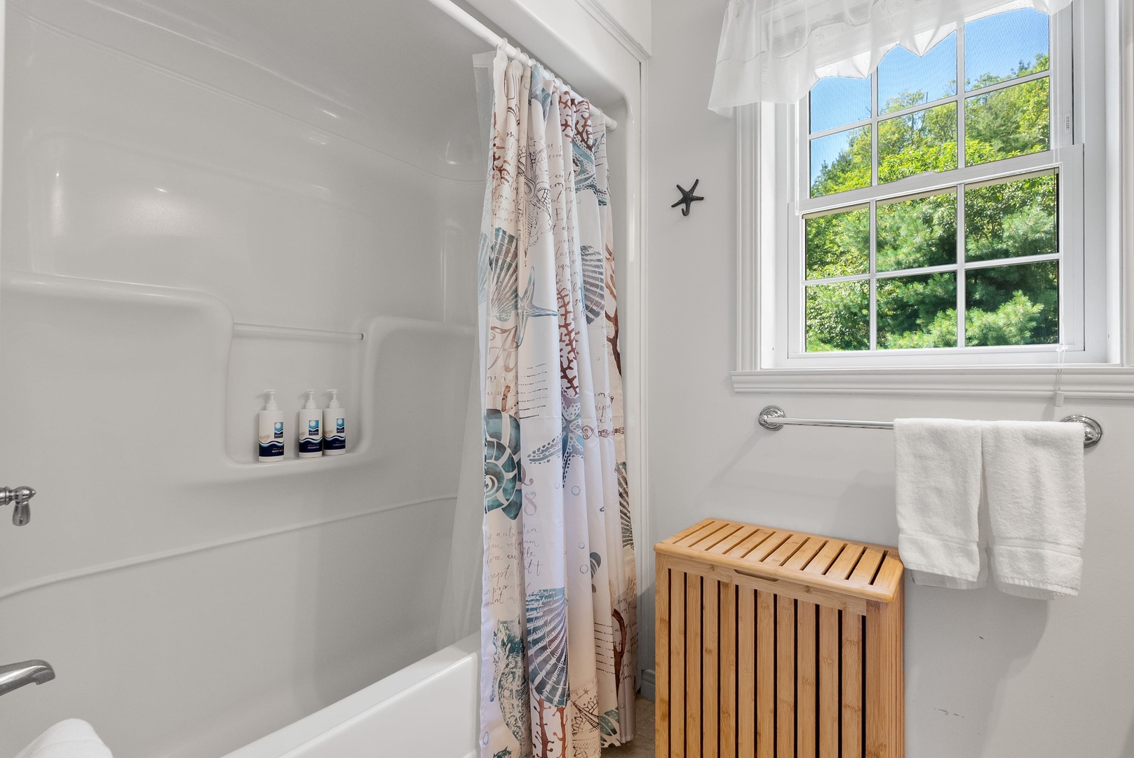 Full bathroom with walk in shower in the hall.