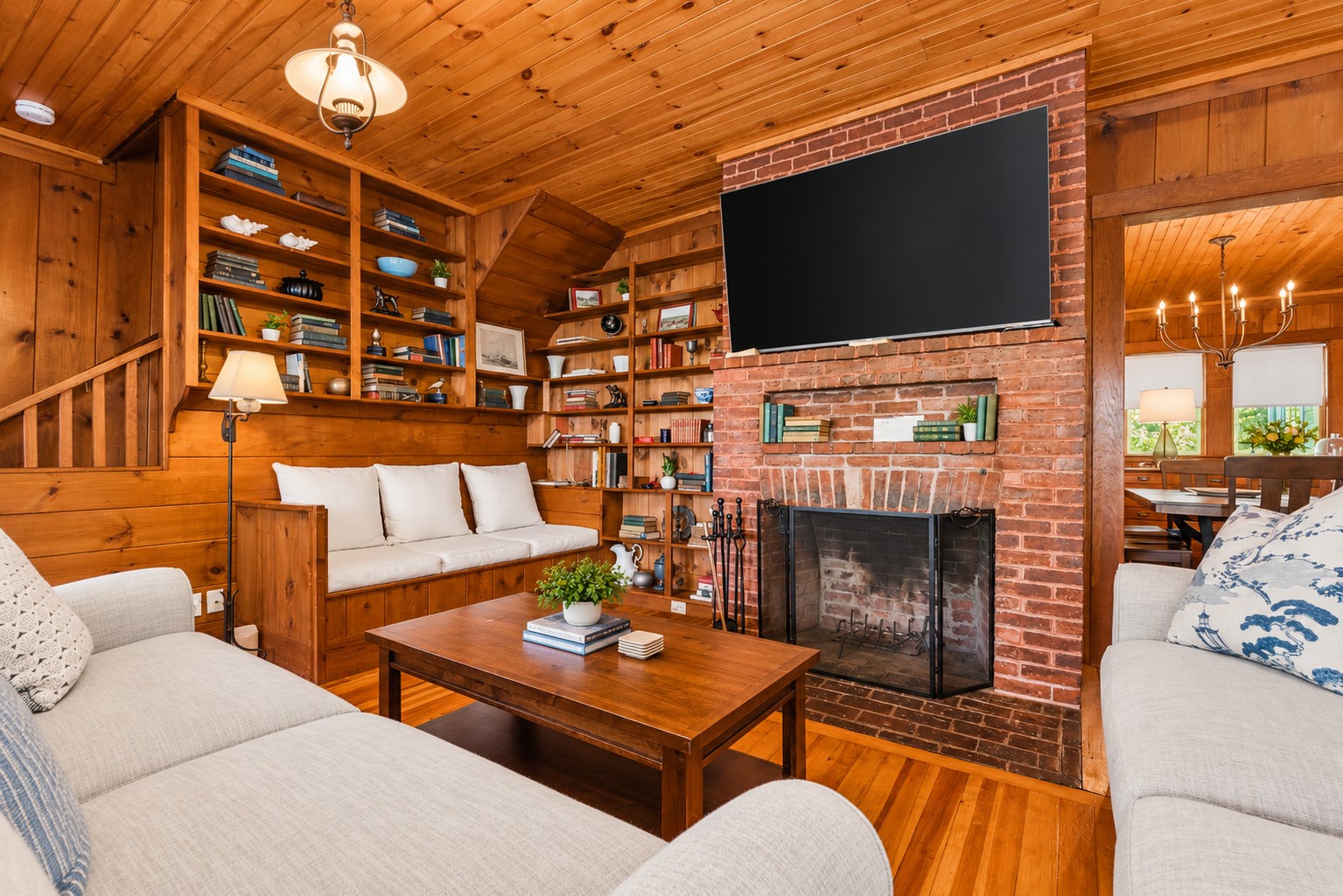 Living room features a large TV above the fireplace.