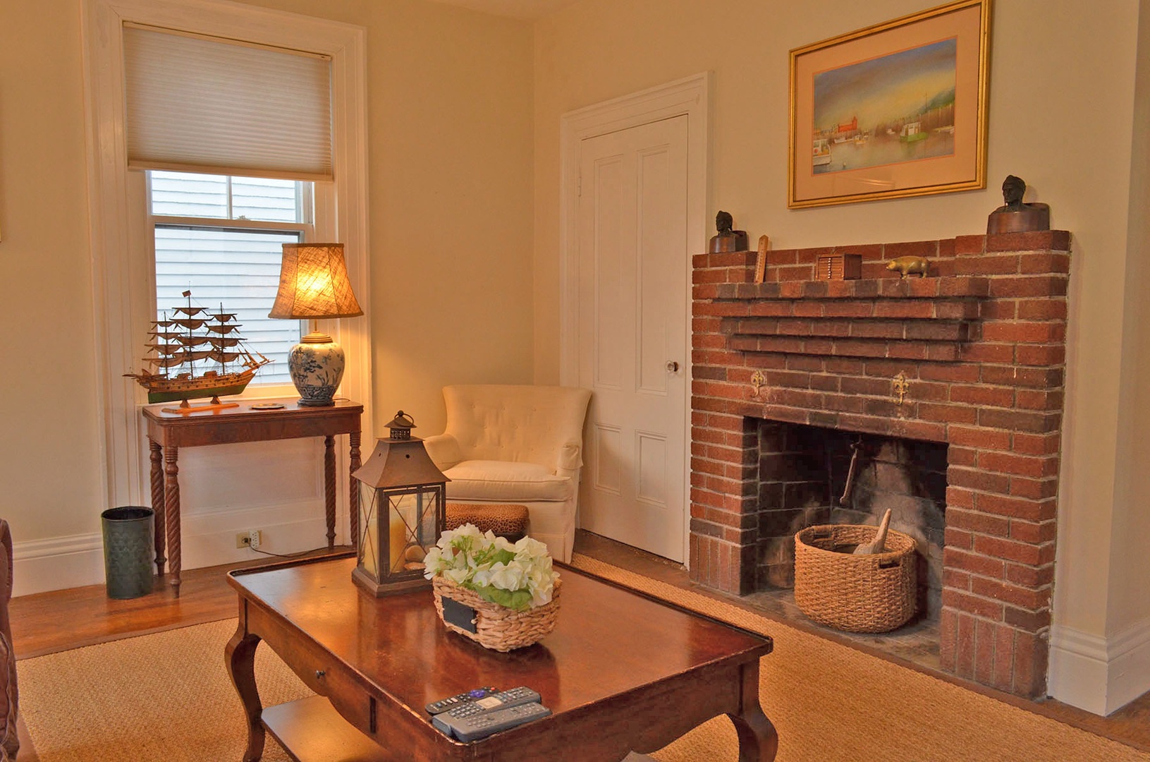 Living room with original fireplace.