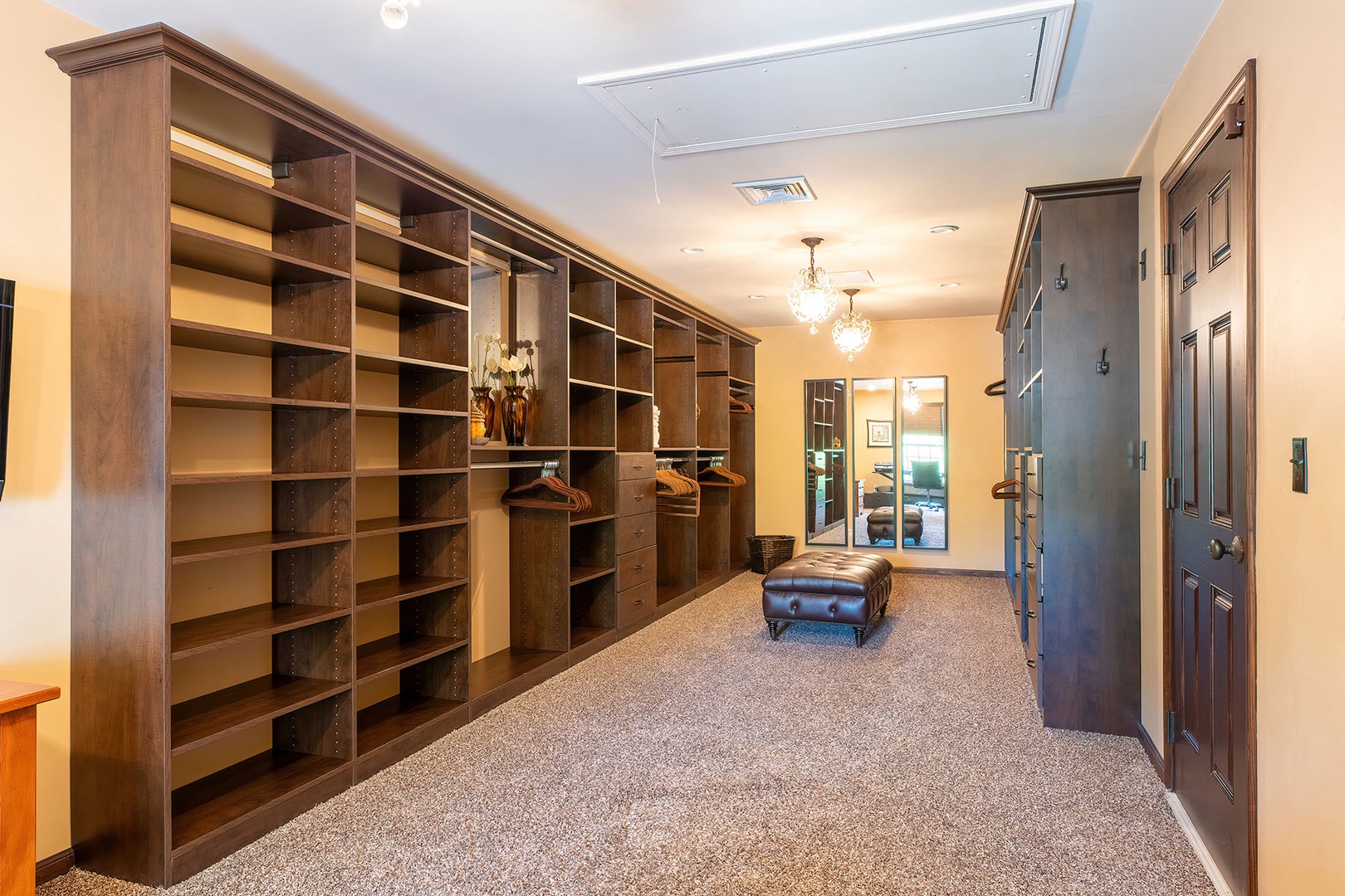 Primary walk-in closet with door to apartment