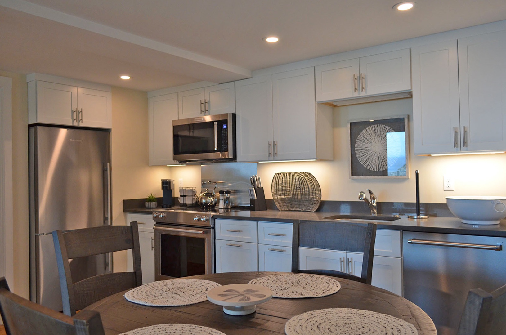 The well-applianced kitchen and dining table.