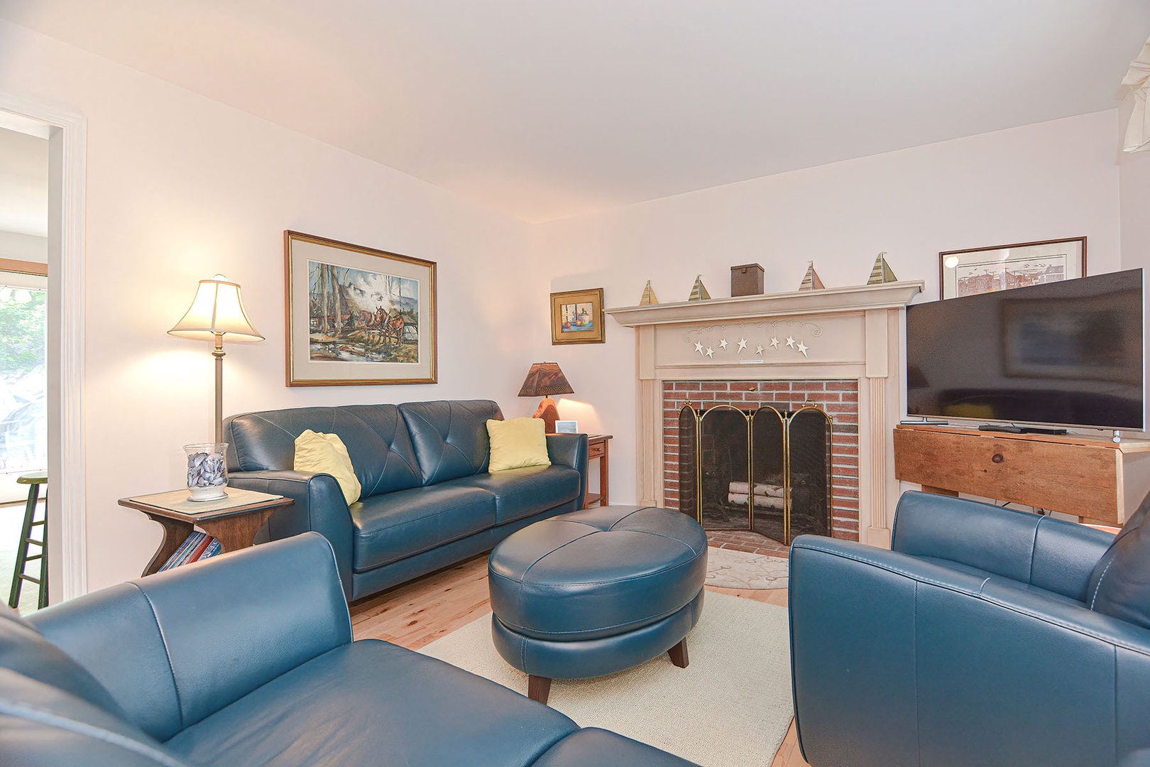 Living room with leather sofas and fireplace.