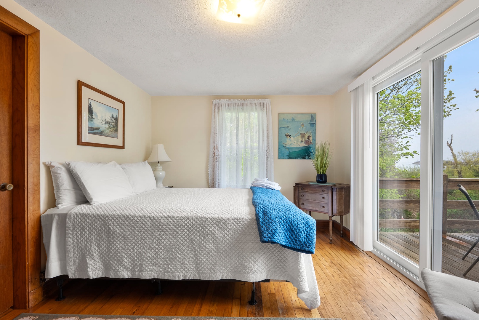 The primary bedroom with a queen bed and access to the deck.