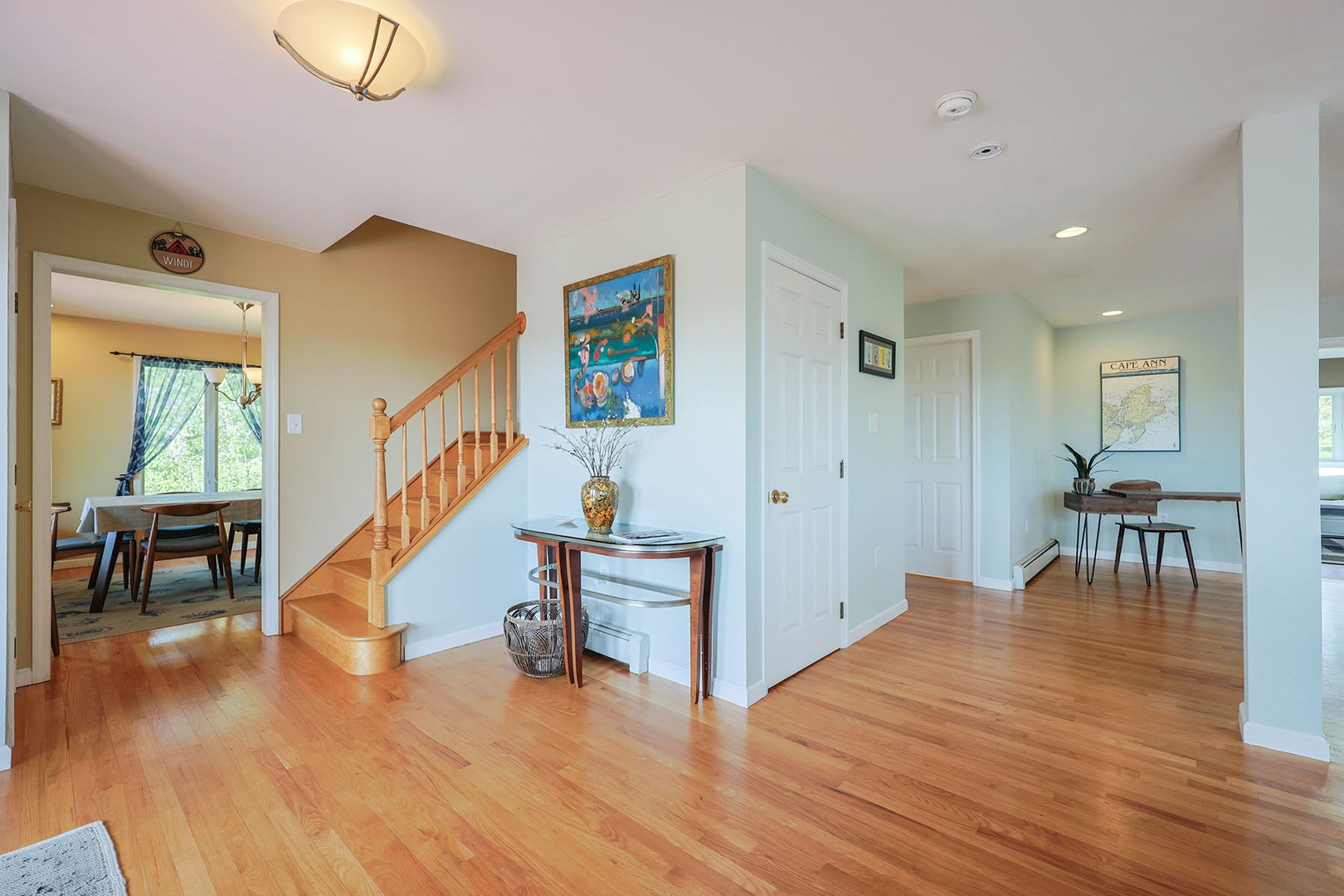 Stairway leading upstairs along with the door to basement